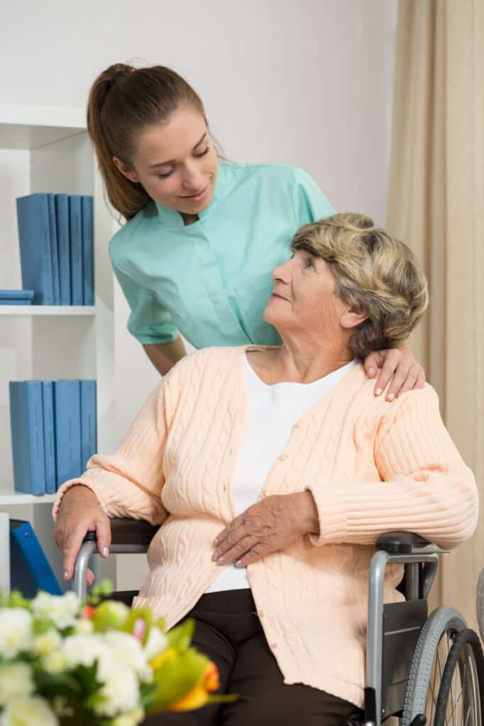 Disabled woman talking with nurse