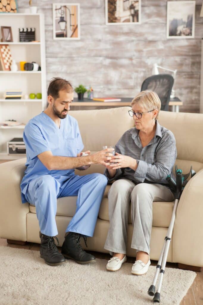 Doctor in nursing home helping senior woman
